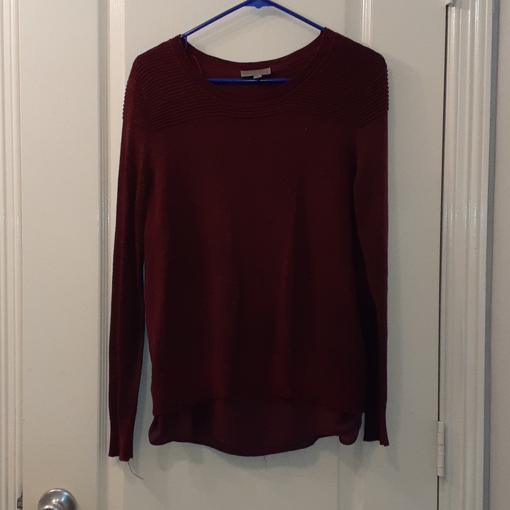 A maroon sweater